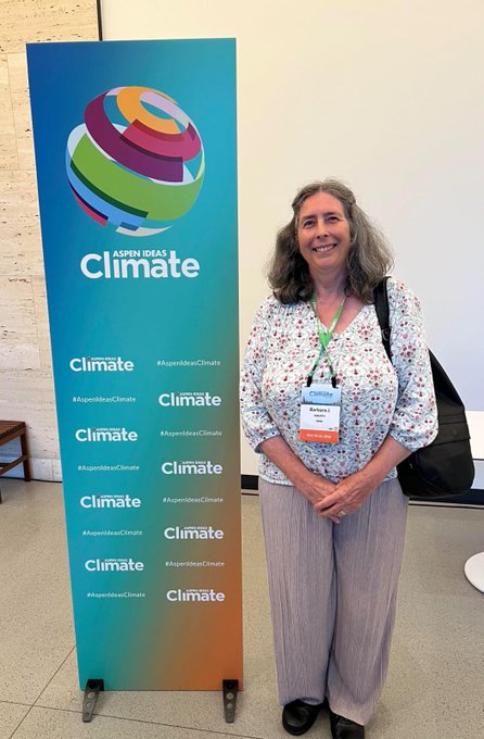 Dr. Barbara J. Sneath at the Aspen Ideas Climate event beside the Aspen Ideas Climate signage